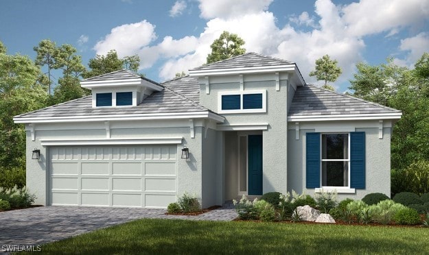 view of front of house featuring a garage, decorative driveway, and stucco siding