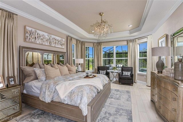 bedroom with an inviting chandelier, crown molding, a raised ceiling, and light wood finished floors