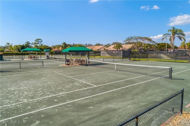 view of tennis court featuring fence