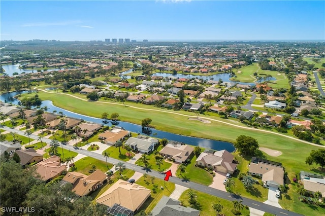 bird's eye view with view of golf course, a water view, and a residential view