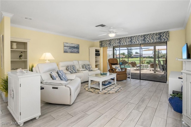 living area featuring wood finish floors, crown molding, and ceiling fan