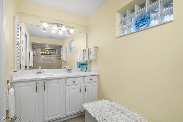 full bathroom featuring a stall shower and vanity