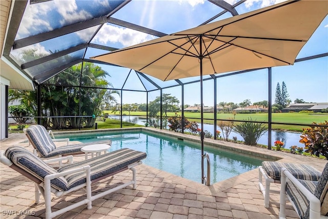 outdoor pool featuring a water view, a patio area, and glass enclosure