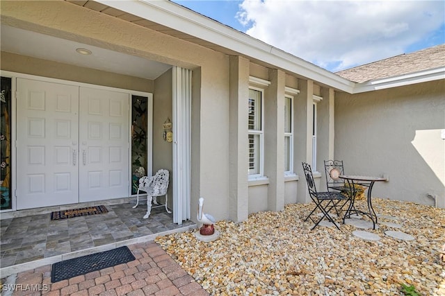 view of exterior entry with stucco siding