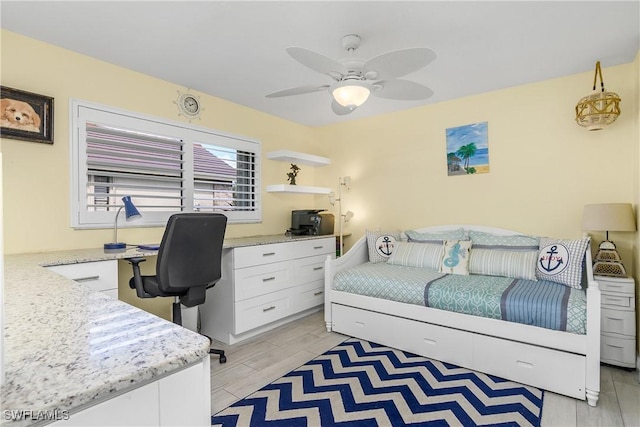 home office featuring wood tiled floor and ceiling fan