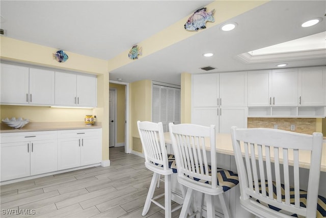 dining area with recessed lighting, visible vents, and light wood-style floors