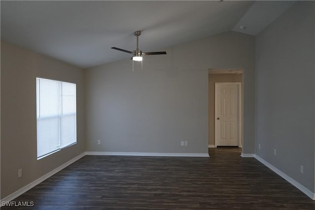 empty room featuring ceiling fan, lofted ceiling, and dark hardwood / wood-style floors