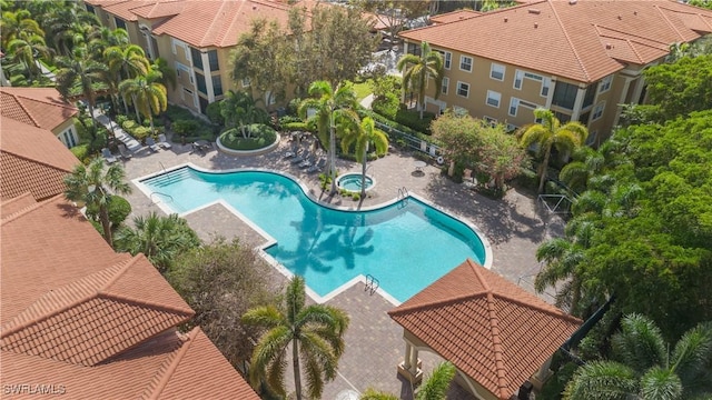 view of swimming pool with a community hot tub and a patio area