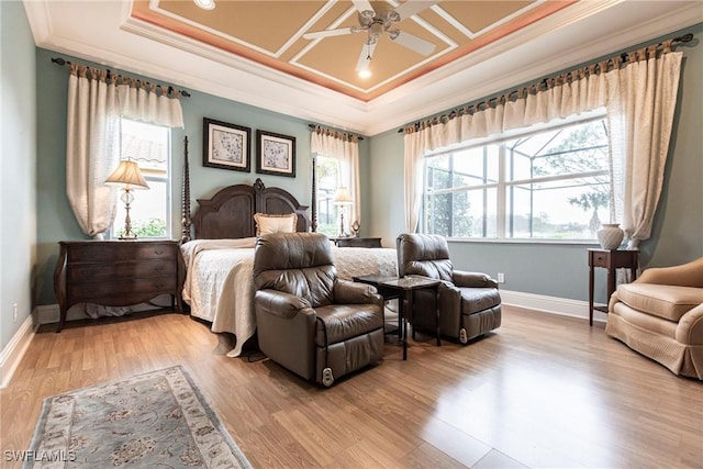 bedroom featuring ceiling fan, ornamental molding, coffered ceiling, and light hardwood / wood-style floors