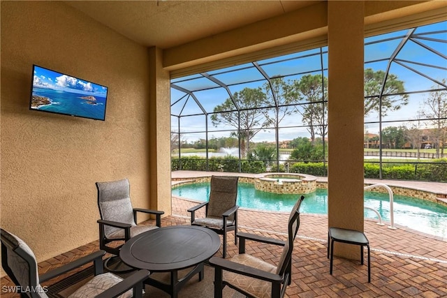 view of pool featuring an in ground hot tub, a lanai, and a patio area