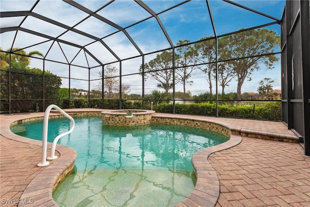 view of pool with an in ground hot tub, a patio, and glass enclosure