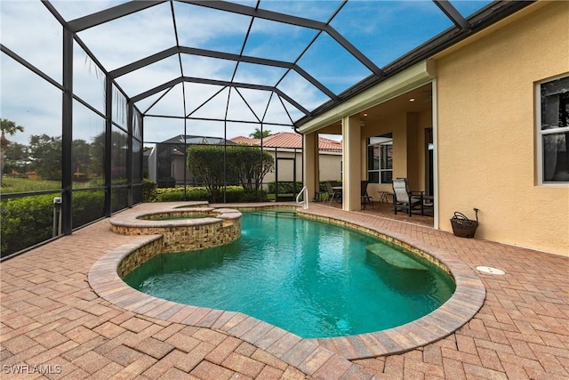 view of pool with a lanai, a patio, and an in ground hot tub