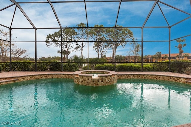 view of swimming pool featuring glass enclosure and an in ground hot tub