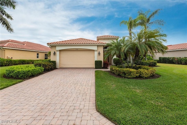 mediterranean / spanish-style house with a garage and a front lawn