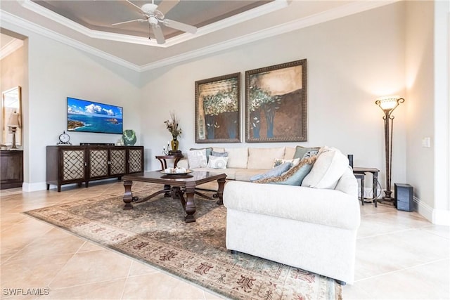 living room with crown molding, ceiling fan, tile patterned floors, and a tray ceiling