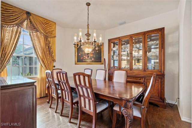 dining room featuring hardwood / wood-style flooring and a chandelier