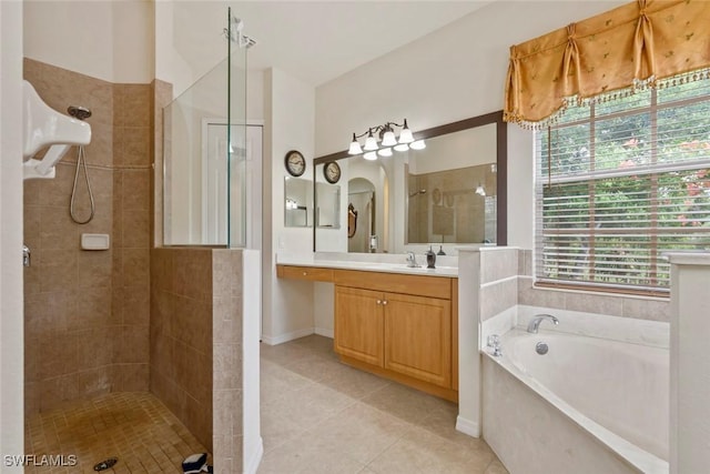 bathroom with independent shower and bath, vanity, and tile patterned floors