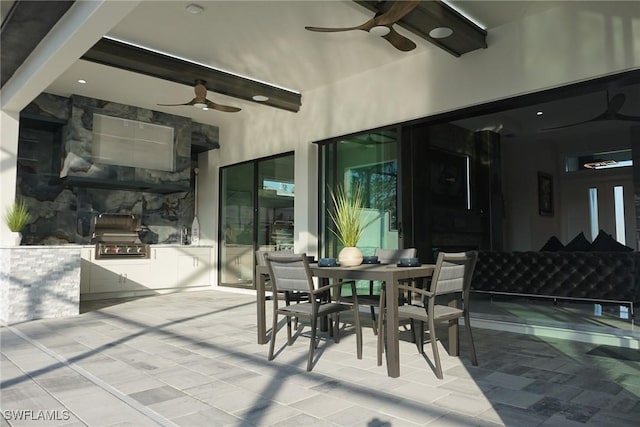 view of patio featuring exterior kitchen, ceiling fan, and grilling area