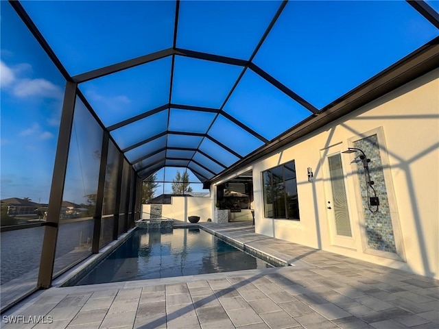 view of swimming pool featuring a patio and glass enclosure