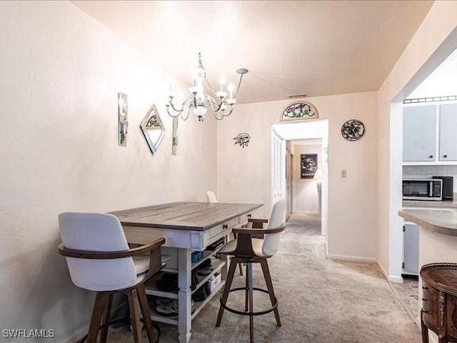 carpeted dining space with a notable chandelier