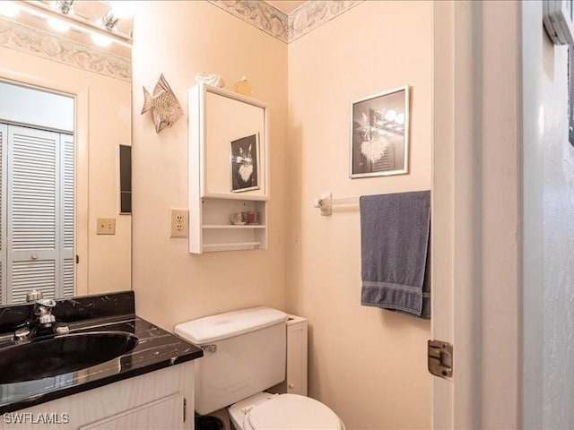 bathroom featuring vanity and toilet