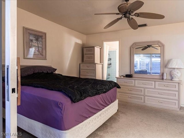 carpeted bedroom featuring connected bathroom and ceiling fan