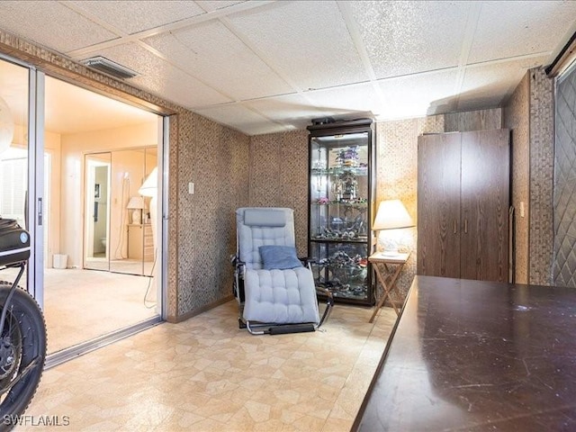 sitting room with a paneled ceiling