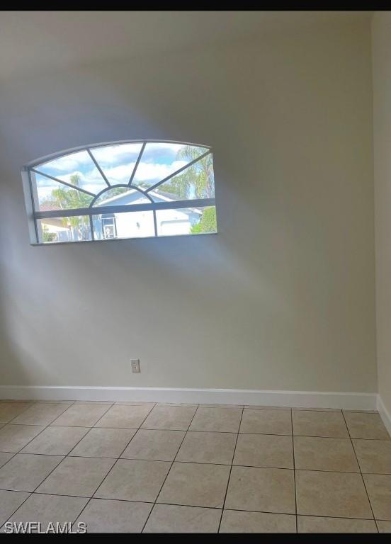 unfurnished room with light tile patterned floors