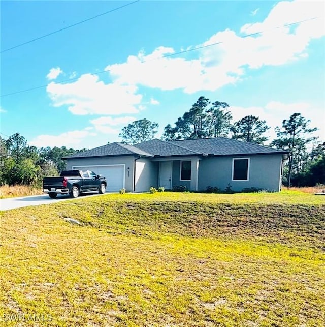 ranch-style home with a garage and a front lawn