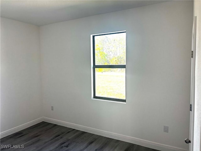 empty room with dark hardwood / wood-style floors