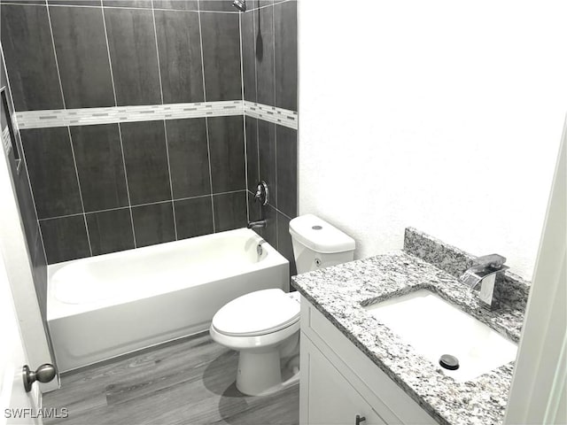 full bathroom with vanity, hardwood / wood-style flooring, bathtub / shower combination, and toilet