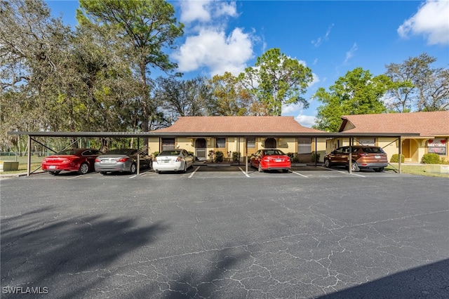 view of vehicle parking with a carport