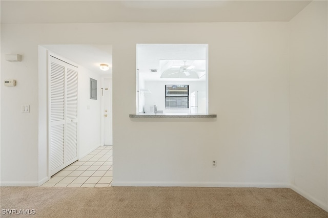 empty room featuring light carpet and ceiling fan