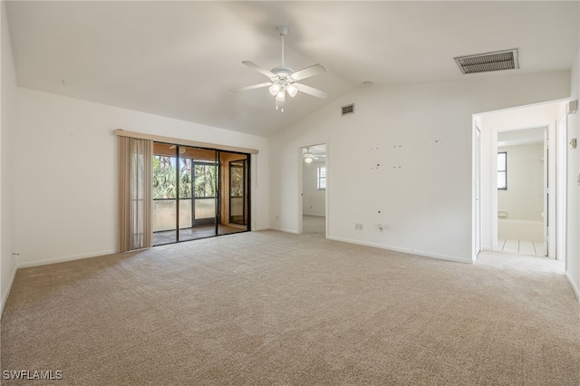 empty room with lofted ceiling, carpet flooring, and ceiling fan