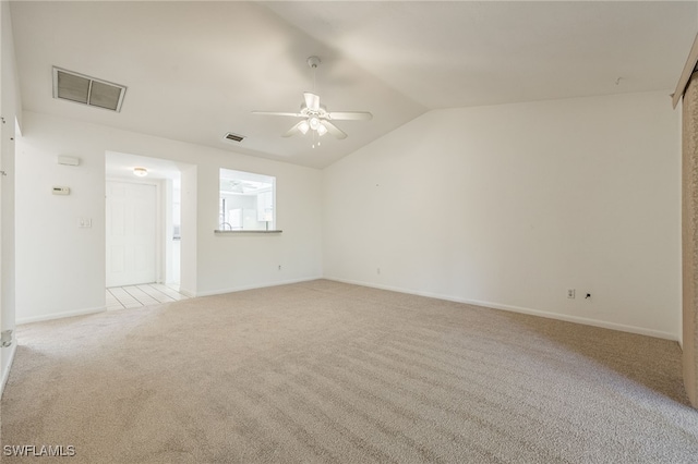 carpeted spare room with vaulted ceiling and ceiling fan