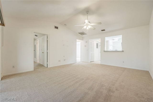 carpeted spare room with vaulted ceiling and ceiling fan