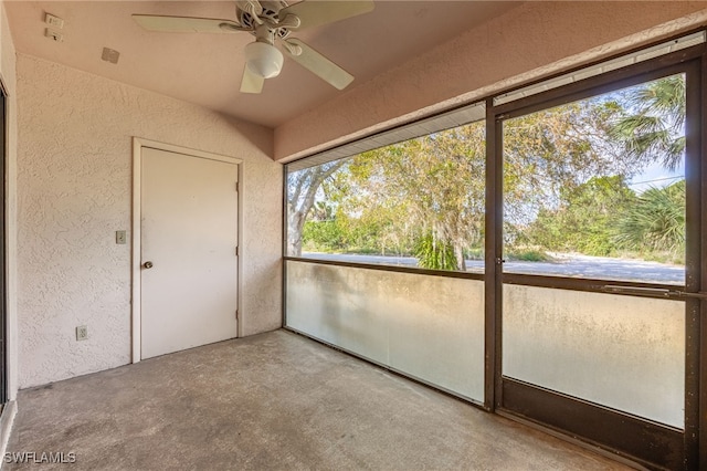 unfurnished sunroom with ceiling fan