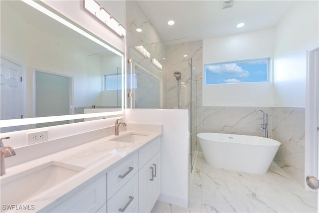 bathroom with shower with separate bathtub and vanity