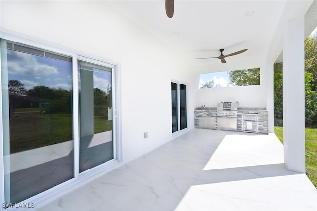 view of patio with exterior kitchen, a grill, and ceiling fan