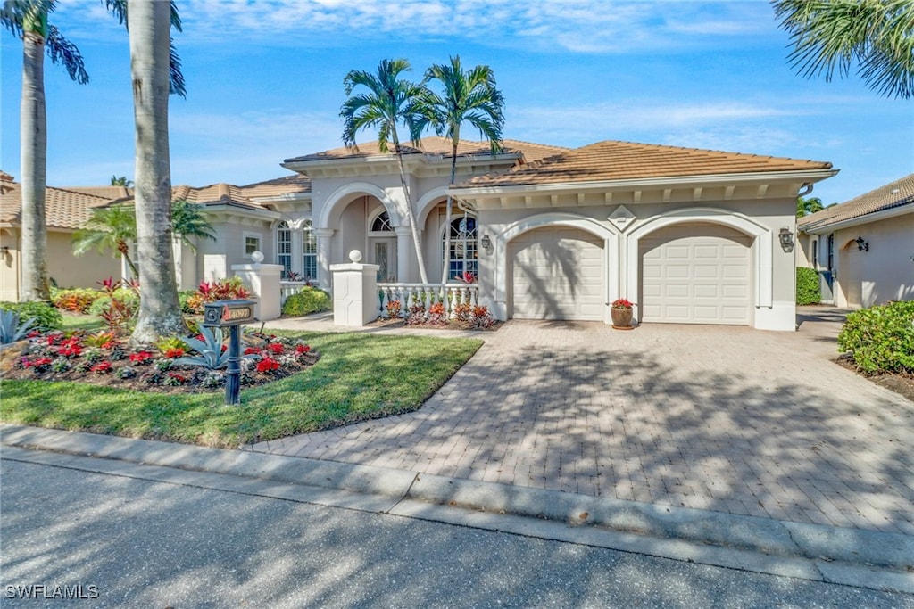 mediterranean / spanish-style house with a garage