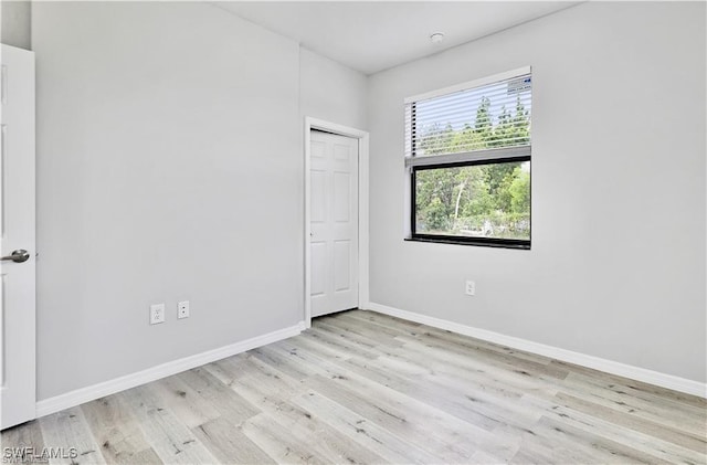 unfurnished room with light wood-type flooring