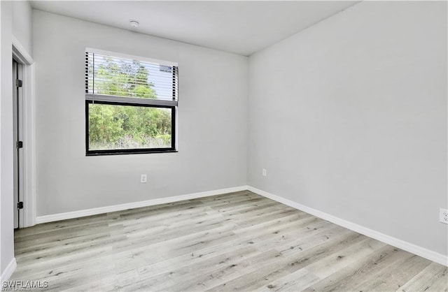 spare room featuring light wood-type flooring