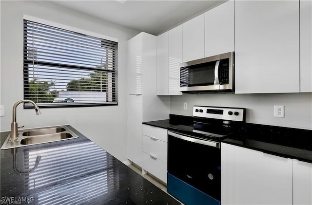 kitchen featuring white cabinetry, stainless steel appliances, and sink