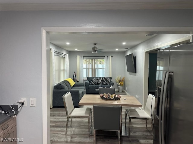 dining space featuring dark wood-type flooring and ceiling fan