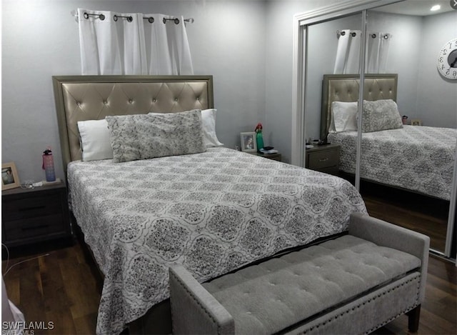 bedroom featuring dark hardwood / wood-style floors and a closet