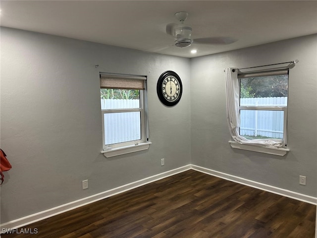 spare room with ceiling fan and dark hardwood / wood-style flooring