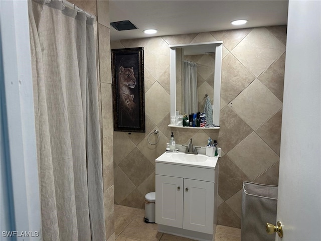 bathroom featuring vanity, tile patterned flooring, a shower with curtain, and tile walls