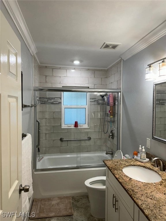 full bathroom featuring toilet, ornamental molding, shower / bath combination with glass door, and vanity