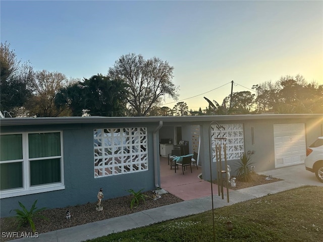 property exterior at dusk with a garage