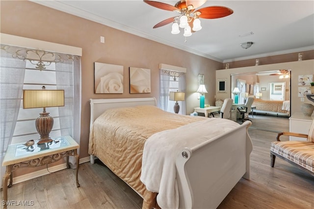 bedroom featuring crown molding, wood-type flooring, and multiple windows